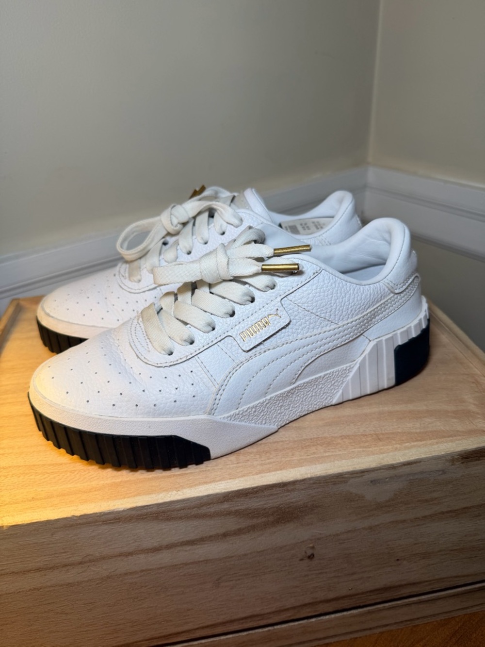 Puma Cali Women’s White Leather Sneakers with Black Sole Panels and Gold Accents